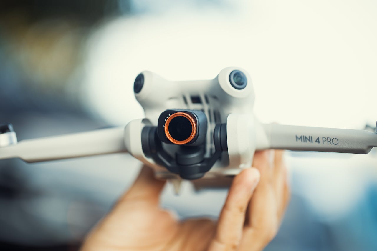 Detailed close-up of a Mini 4 Pro drone, showcasing its camera lens and design. Ideal for tech and gadget enthusiasts.